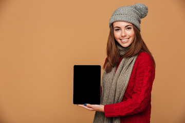 Smiling caucasian lady showing display of tablet computer.