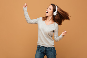 Emotional caucasian lady dancing isolated listening music