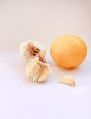 Garlic heads and lemon against colds on a white background