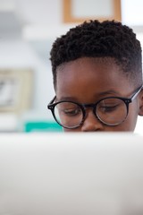 Close up of businessman wearing eyeglasses using computer