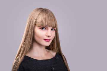 blonde beautiful fashion girl with bang over gray background