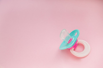 Baby Pacifier mint blue on pink background closeup. the baby stuff. place for text