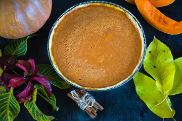Pumpking pie on black wooden desk. Homemade pie. Thanksgiving dinner. Autumn