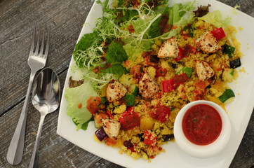 Сouscous with cheese paneer and vegetables with salad mix and tomato sauce