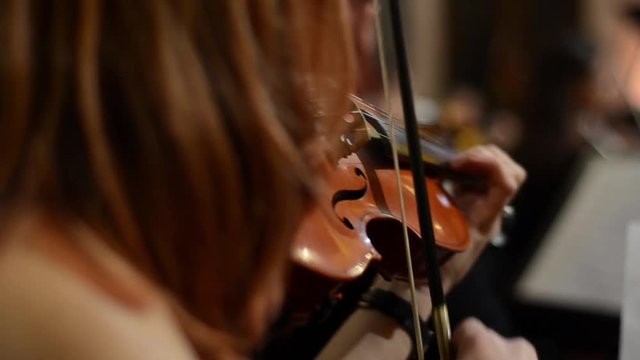 Woman playing violin. Classical music concert. Close up