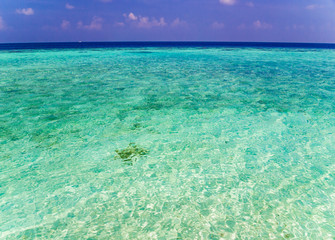 Tropical island vacation image, turquoise blue crystal clear water