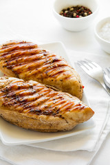 Grilled chicken breast on white table cloth