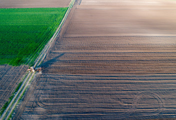 Tractor harrowing soil