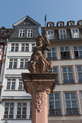 the minervabrunnen in front of the half-timbered houses on Roemerberg in Frankfurt, Germany