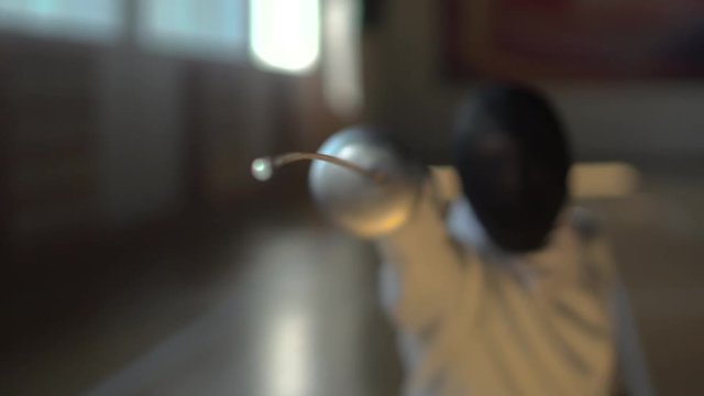 Fencer attacks in the gym
