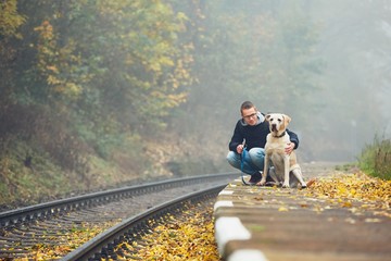 Fototapeta premium Man traveling with his dog by train