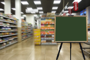 Supermarket, shelves with goods. Defocused image. Place in a wooden frame for your text or advertisement.