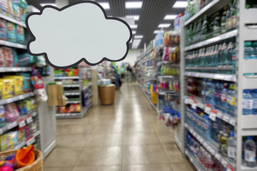 Shop products, supermarket. Shelves with food. Defocused image. Place for your text or advertisement.