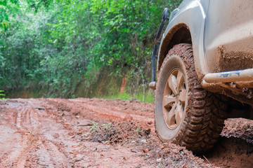 Fototapeta na wymiar Wheel closeup in a countryside landscape with a muddy road