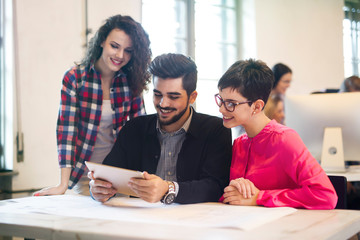 Group of young architects using digital tablet