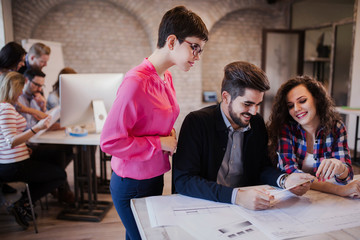 Group of young architects looking at digital tablet
