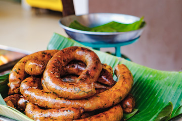 Close up of Thai grilled pork sausage on banana leaf - tradition Thai food.