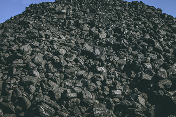 A big heap of natural black coal on a career