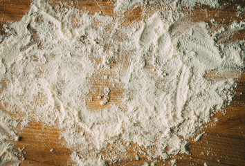 White flour on a wooden cooking desk. Abstract texture.