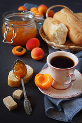 Apricots, apricot jam  in jam jar and cup of coffee