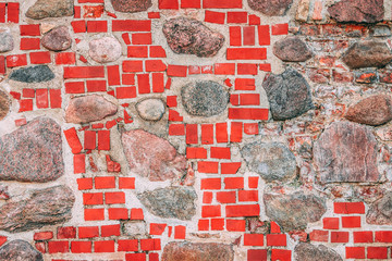 Wall constructed of stones and red bricks, a part of old castle