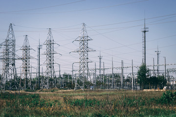 Power line posts against the clear blue sky