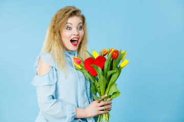 Pretty woman with red yellow tulips bunch