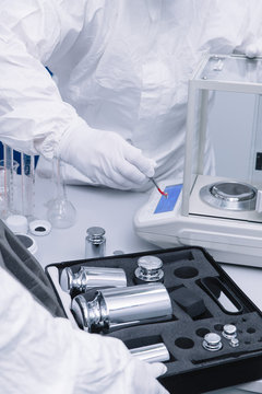 Scientists using scales in lab