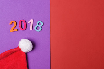 2018 colorful numbers and santa hat on paper backround, minimal style.