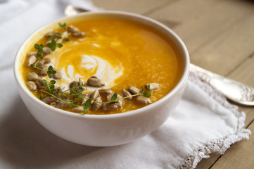 Vegetarian pumpkin soup on a wooden table.