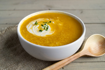 Vegetarian pumpkin soup on a wooden table.