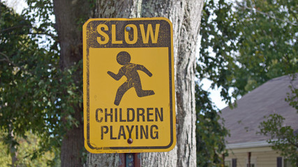 Isolated photo of a street sign that reads CHILDREN PLAYING