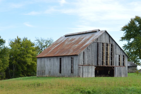 Rural landscape photo of an old rustic barn on a farm in the country