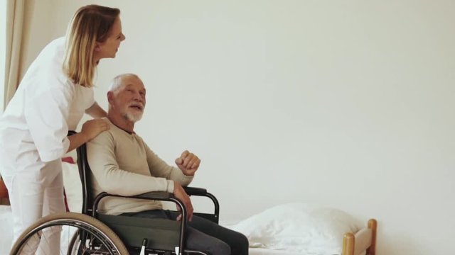 Health visitor and a senior man during home visit.
