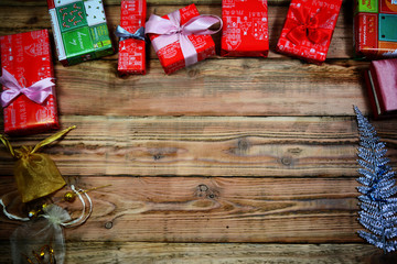 Fototapeta na wymiar the christmas gift boxes on the wooden table with space