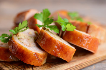 Stuffed chicken rolls. Sliced chicken rolls on a wooden board. Closeup