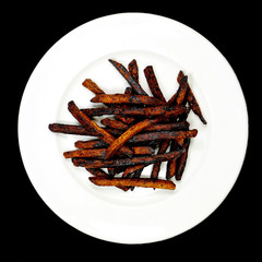 Charred potato slices  on a white plate charred French Fries