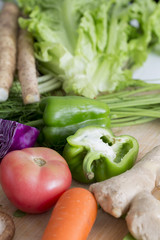 Closeup of fresh vegetables on wooden table.