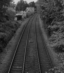 Fototapeta na wymiar a top down view of a railway in black and white with it turning round to the right