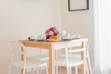 Table set for the breakfast. Breakfast concept. White interior
