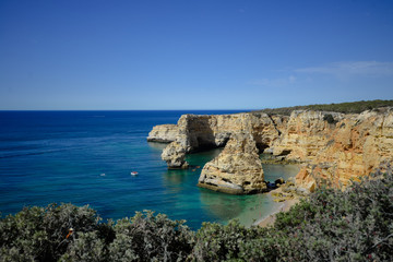 Fototapeta na wymiar Algarve coastline and beautiful sunny cliffs ocean natural outdoors background. Idyllic dream travel destination