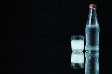 Cold vodka on a black background.