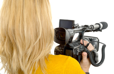 blond young woman with professional camcorder, back view, on white