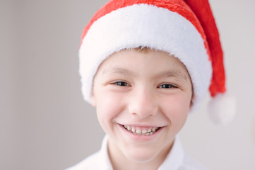 cute smiling boy in Santa hat
