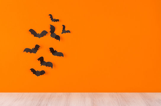 Halloween orange blank background with bats flock and white wooden board shelf.