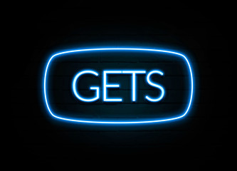Gets  - colorful Neon Sign on brickwall