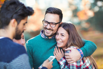 Group of young people in park with smart phone