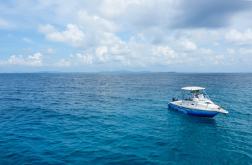Speed boat floating in the beautiful ocean with blue sky