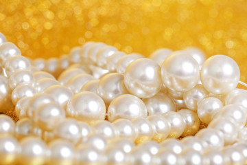 Pile of pearls on golden christmas background