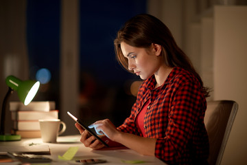student girl or woman with tablet pc at night home